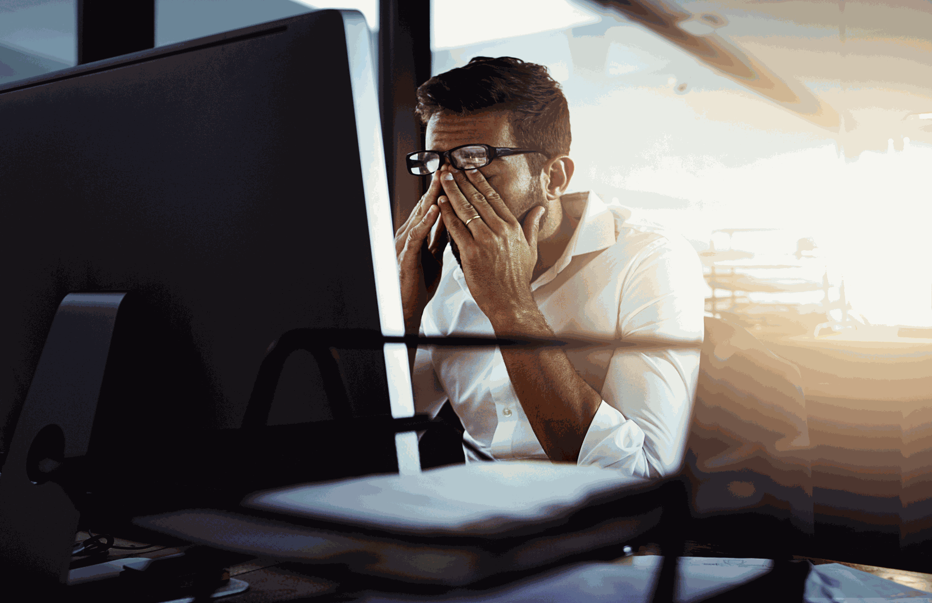 Image shows a Frustrated employee suffering from a tradional HR System